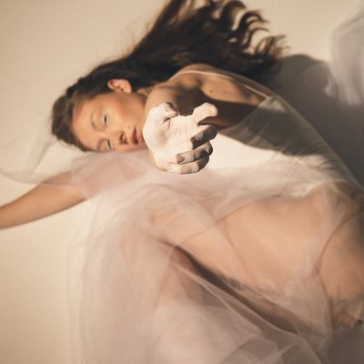 Person's hands in a graceful, flowing gesture.